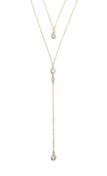 féminin et élégant, le collier de dos ELIA, réalisé en plaqué or Gold filled* 14 carats, est composé de quatre zircons étincelants.